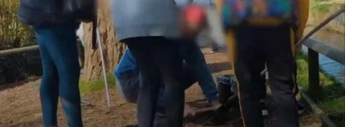 People standing at trout farm